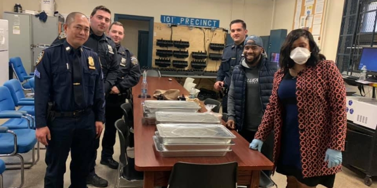 Sanders' Office Manager, Lisa George helps deliver meals to the 101st Precinct.