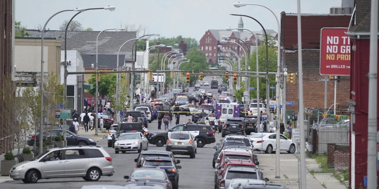 Police vehicles block off the street where at least 10 people were killed in a mass shooting at a Buffalo supermarket. (Derek Gee/The Buffalo News/AP)