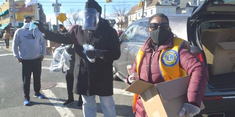 Senator Sanders, center, was joined by members of the Richmond Hill / South Ozone Park Lions Club and distributed PPE to passersby on foot and those driving by in their cars.