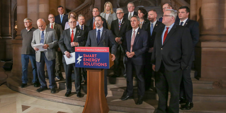 (At podium: Senate Republican Leader Rob Ortt; Also pictured: Members of the Senate Republican Conference; (Left to Right)Wayne Stritsman – Founder of a family business, Best Fire Hearth & Patio in 1977; and Richard Ellenbogen, President Allied Converters)