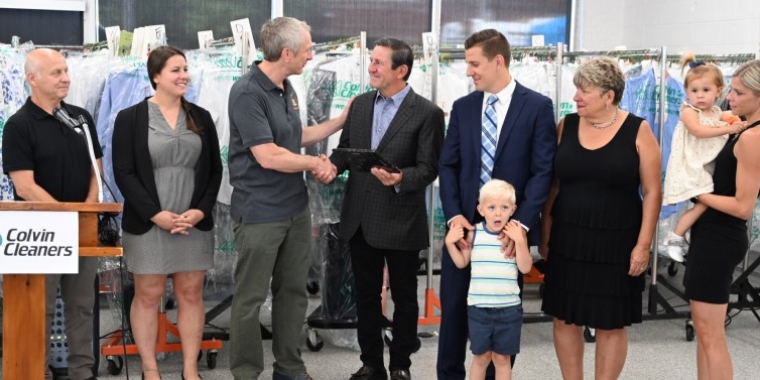 Village of Kenmore Mayor Patrick Mang (left) and Senator Sean Ryan present the Billoni family with a New York State Senate Empire Award, July 7, 2022