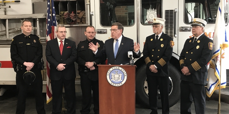 Senator Seward discusses new legislation to increase criminal penalties for individuals who cause a fire or explosion while manufacturing illegal drugs at a press conference at the Homer Fire Department. From left, Cortland County Sheriff's Department Captain Robert Derksen, Cortland County District Attorney Patrick Perfetti, Homer Police Chief Robert Pitman, Senator James L. Seward, Homer Fire Chief Mahlon Irish, former Homer Fire Chief Bob Johnson.