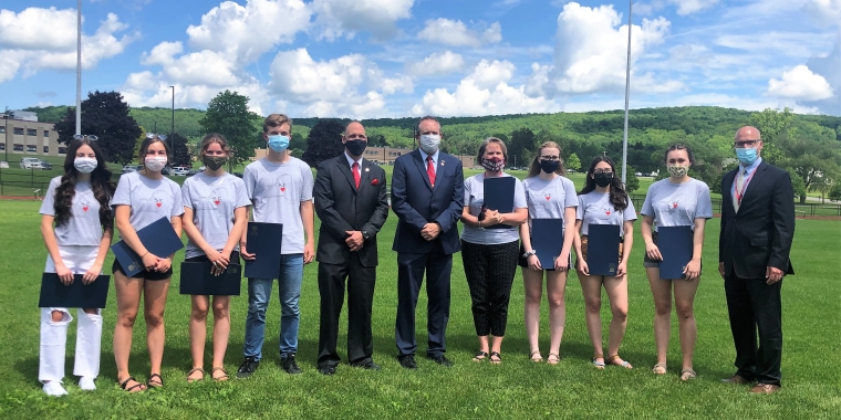 Senator Peter Oberacker and Assemblyman John Lemondes present legislative resolutions to members of the Sherburne-Earlville Central School District Odyssey of the Mind state championship team. From left, Anna Fern, Maleah Britton, Lily French, Peter Peschel, Assemblyman Lemondes, Senator Oberacker, teacher/coach Heidi Johnson, Jennifer Adsit, Lillie Ashton, Justiss Kovack, Superintendent Robert Berson.