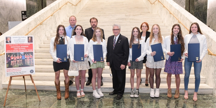 Sheridan Wheeler, Emily Bush, Alycia Hart, Heidi Berglund, Natalie Wilding, Anya Belisle, and McKinley Wheeler, along with Head Coach, Art Kranick, and Assistant Coaches Linda Kranick and Dan VanCott