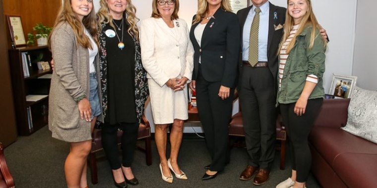 From left: Trinity Folk, Donna Besler, Senator Helming, Tiffany and Christopher Folk, and Calista Folk.
