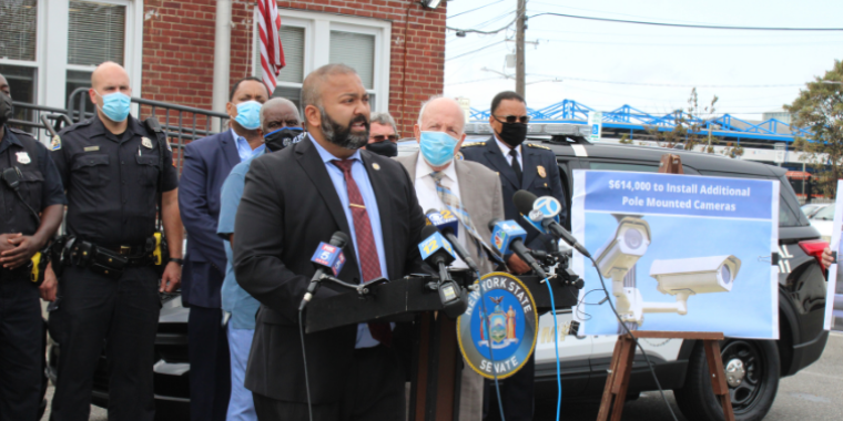 Senator Kevin Thomas announces over $900k in funding to support the Hempstead Village Police Department, flanked by Hempstead Village Mayor Don Ryan, Hempstead Village Trustees, and law enforcement officers.