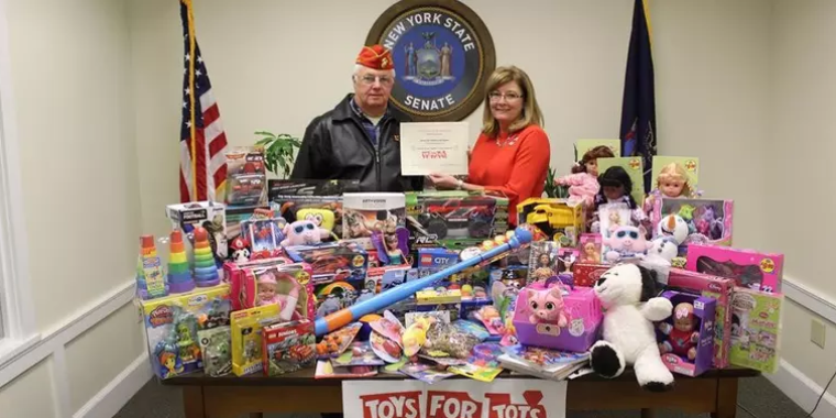 Marine Corps League Memorial Day Detachment No. 468 Senior Vice Commandant David Brisbane presents a certificate to Senator Pam Helming to thank her for her participation in her annual Toys for Tots program.