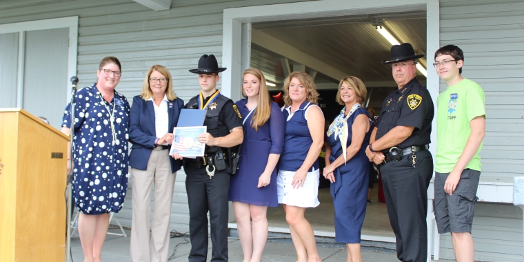 From left to right: Wayne County Fair Board President Pam Ferranti, Senator Pam Helming, Wayne County Sheriff’s Deputy Thomas Munzert, Deputy Munzert’s fiancé Alexandra McKay, his future mother-in-law Peggy McKay, his mother Sue O’Brien, Wayne County Sheriff Barry Virts, and Wayne County Fair Apprentice Tristan Gellatly.