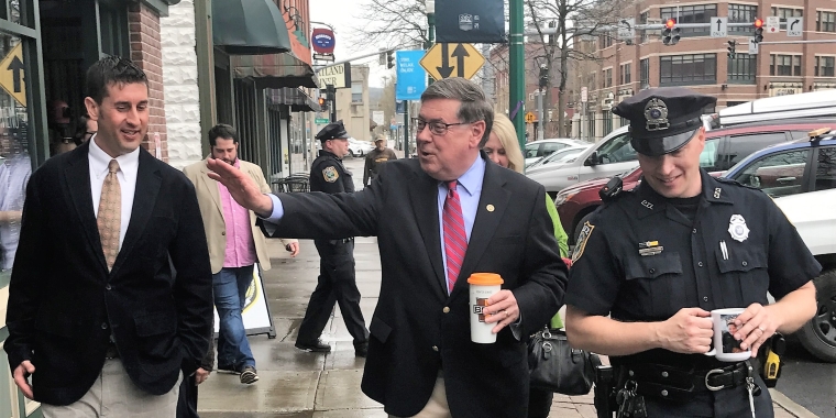 Sentator James L. Seward walks along Main Street Cortland to review several new downtown renovations and planned development projects. From left, Cortland Downtown Partnership Executive Director Adam Megivern, Senator Seward, Cortland Community Police Officer Jesse Abbott.