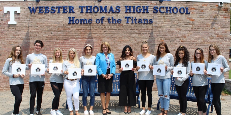 Senator Pam Helming with Coach Michelle Byam and members of the Webster Thomas Titans cheerleading team that won the New York State Co-Ed Division championship during the winter season.
